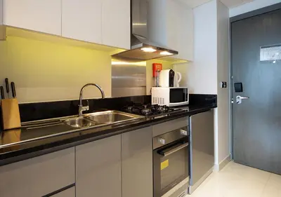 a kitchen with a sink and a microwave at Burj Khalifa & Canal View LuxeStudio in DAMACPrive in Dubai