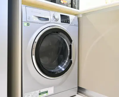 a washer and dryer in a laundry room at Luxurious One Bed Near Dubai Mall with Burj and Canal View in Dubai