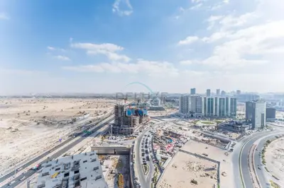an aerial view of a city with a beach at Near Dubai Miracle Garden 1BR with Private Balcony, Orchid Residence, Al Barsha South by Deluxe Holiday Homes in Dubai
