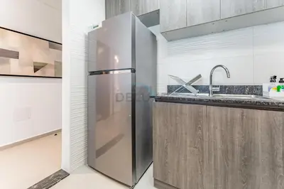 a stainless steel refrigerator in a kitchen at Near Dubai Miracle Garden 1BR with Private Balcony, Orchid Residence, Al Barsha South by Deluxe Holiday Homes in Dubai