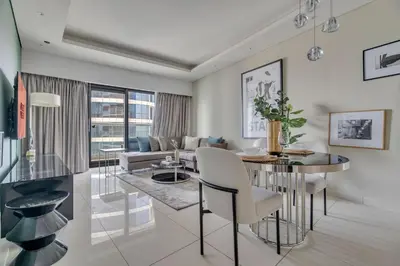 a living room with a dining table and a couch at GuestReady - Stylish home in Business Bay in Dubai