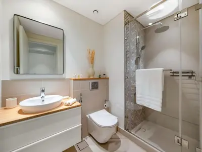 a bathroom with a sink and a toilet and a shower at Contemporary 1BR in Collective 2.0 Luxury and Comfort in Dubai