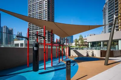 awning over a playground in a city with tall buildings at New Build Luxury with Burj View at Peninsula 5, Business Bay in Dubai