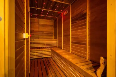an empty sauna with wooden walls and wooden floors at New Build Luxury with Burj View at Peninsula 5, Business Bay in Dubai