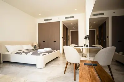 a bedroom with a bed and a table and chairs at New Build Luxury with Burj View at Peninsula 5, Business Bay in Dubai