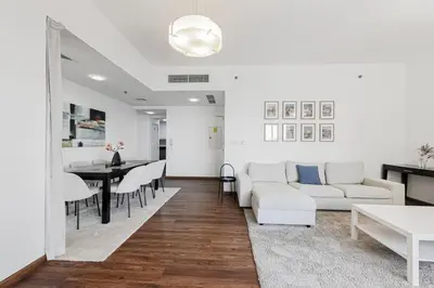 a living room with a couch and a table at Short Stay Apartment Shams 1 Jumeirah Beach Residence 2 Bed Sleeps 6 - DVH HOLIDAY HOMES in Dubai