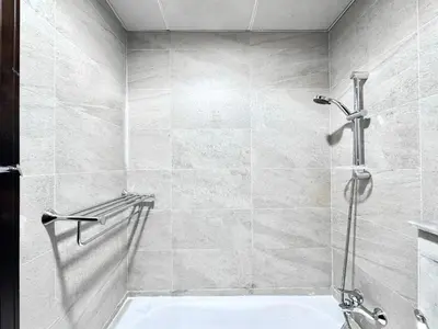 a bathroom with a shower and a bath tub at Al Manara Classic Cozy Studio in Dubai