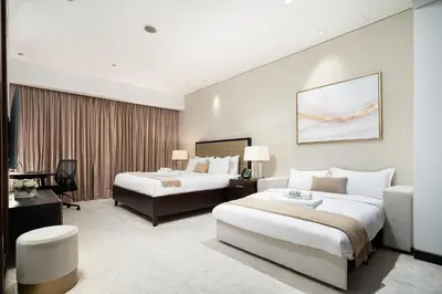 a hotel room with two beds and a couch at JW Marriott Marina By Luxe Living Collection - Wane By Somiya Infinity Pool in Dubai
