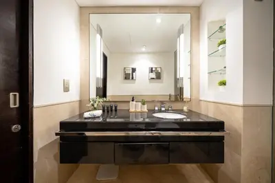a bathroom with a sink and a large mirror at JW Marriott Marina By Luxe Living Collection - Wane By Somiya Infinity Pool in Dubai