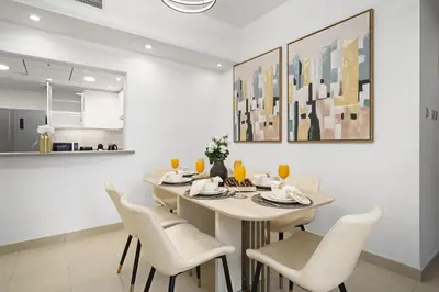 a kitchen and dining room with a table and chairs at Standpoint Tower by Luxe Living in Dubai