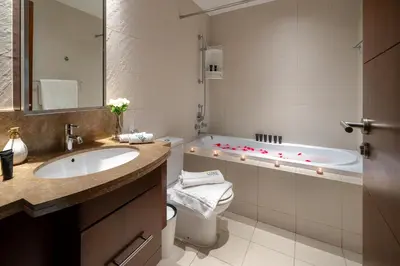 a bathroom with a tub and a toilet and a sink at Standpoint Tower by Luxe Living in Dubai