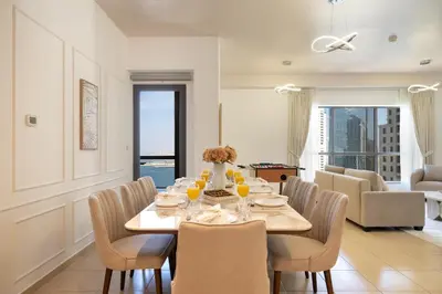 a dining room with a table and chairs at JBR Rimal By Luxe Living - Dubai Eye View in Dubai