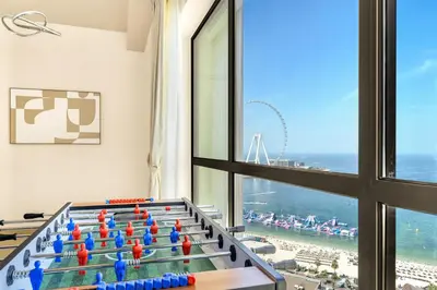 a game room with a view of the beach at JBR Rimal By Luxe Living - Dubai Eye View in Dubai