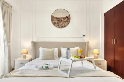 a bedroom with a bed with a table and a mirror at JBR Rimal By Luxe Living - Dubai Eye View in Dubai