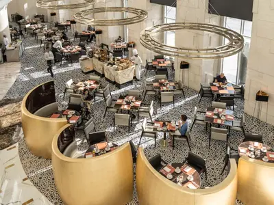 an overhead view of a restaurant with people sitting at tables at Shangri-La Apartments in Dubai