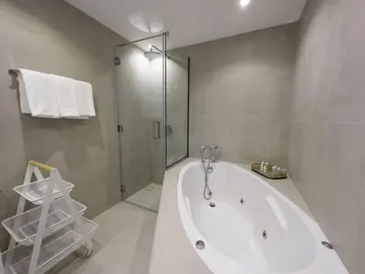 a bathroom with a large white tub and a shower at Appartement Moderne Dubai Marina in Dubai