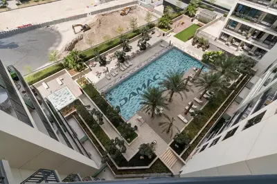 an overhead view of a swimming pool in a building at Stylish 1BR In Zada Tower With Pool Views in Dubai