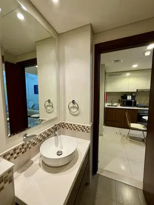 a bathroom with a sink and a mirror at DAMAC Reva 5 mins Walk from Dubai mall in Dubai