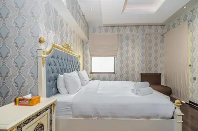 a bedroom with a white bed and blue wallpaper at Artistic penthouse with amazing JBR Beach and sea view in Dubai