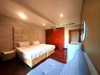 a bedroom with a large bed and a couch at Artistic penthouse with amazing JBR Beach and sea view in Dubai