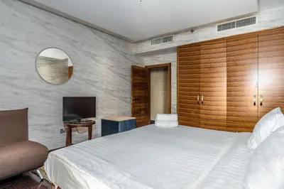a bedroom with a large bed and a television at Artistic penthouse with amazing JBR Beach and sea view in Dubai
