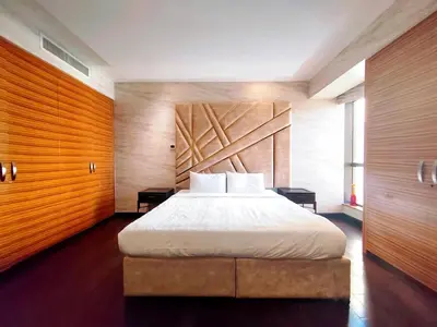 a bedroom with a large bed and wooden walls at Artistic penthouse with amazing JBR Beach and sea view in Dubai