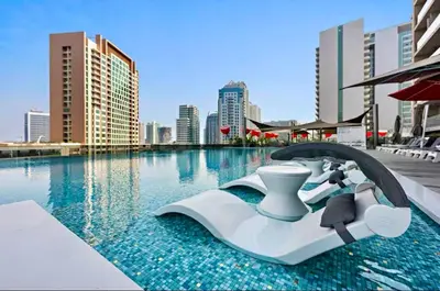 a resort swimming pool with a water slide at Mag 318 - 3 min walk to Dubai Mall - Luxury Studio - Pool & SLS View in Dubai