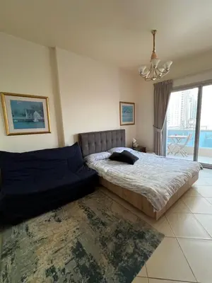 a bedroom with a large bed and a chandelier at Marina Diamond in Dubai