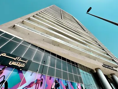 a tall building with a sign on the side of it at Homes2Retreat - Chic & Cozy Studio in Damac in Dubai