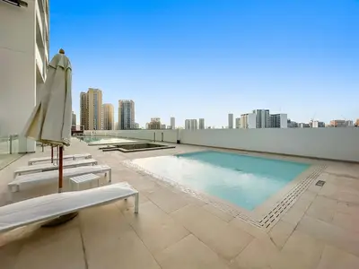 a swimming pool on the roof of a building at FIRST CLASS Studio Touch of Luxury & Comfort in Dubai