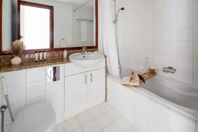 a bathroom with a sink and a tub and a toilet at Frank Porter - Al Yass Tower in Dubai