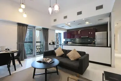 a living room with a couch and a table at Livbnb-Spacious 2 BR in Dubai Marina with Balcony in Dubai