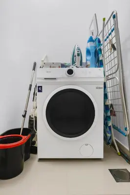a white washing machine sitting on top of a counter at FIRST CLASS 2BR Creek Harbour & Burj Views in Dubai