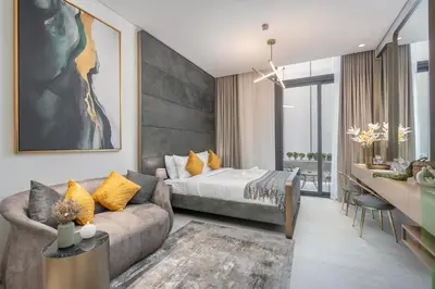a living room with a bed and a couch at Modern Studio by Czechin JVC Prime Location in Dubai