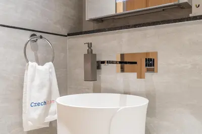 a bathroom with a white tub and a sink at Modern Studio by Czechin JVC Prime Location in Dubai