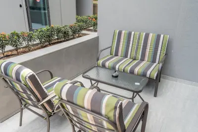 two chairs and a table on a balcony at Modern Studio by Czechin JVC Prime Location in Dubai