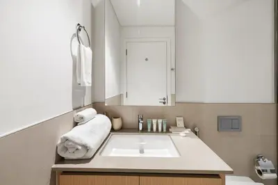 a bathroom with a sink and a mirror at 1BR Summer 4 Direct Beach Access in Dubai