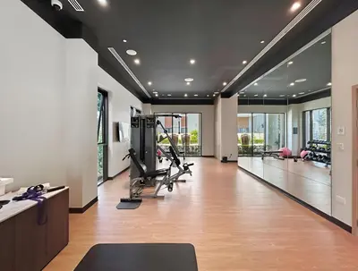 a gym with treadmills and exercise equipment in a room at 1BR Summer 4 Direct Beach Access in Dubai