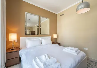 a bedroom with a white bed with towels on it at Luxurious Studio in Downtown Dubai in Dubai