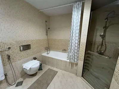 a bathroom with a tub and a toilet and a shower at Spacious and Family Friendly l 3BHK Full Apartment Access in Dubai