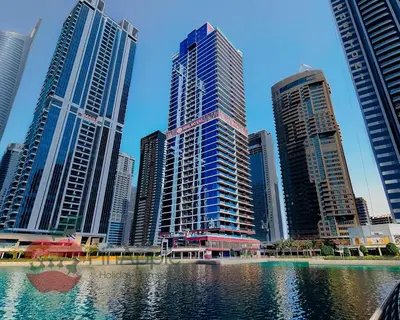 a group of tall buildings in a city with water at Royal style New 1BR with a view in Dubai