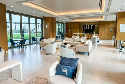 a lobby with couches and chairs in a building at Burj Khalifa View, Luxury Two-Bedroom Residence, PlayStation 5, Swimming Pool and Fitness Center in Dubai