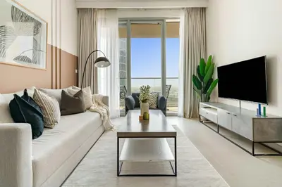 a living room with a couch and a tv at Silkhaus Cozy 1BDR at Forte Tower in Emaar Downtown in Dubai