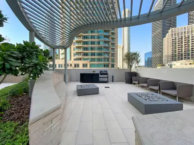 a rooftop patio with a view of a city at Silkhaus Cozy 1BDR at Forte Tower in Emaar Downtown in Dubai