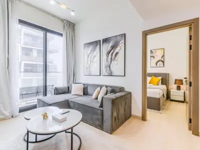 a living room with a couch and a bed at TRPS - Binghatti Nova, Jumeirah Village Circle - Premium 1BR with Great Amenities in Dubai