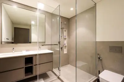 a bathroom with a shower and a sink and a toilet at Livbnb-Modern 2BR with Partial Burj Khalifa View in Dubai