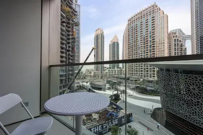 a balcony with a table and a view of a city at Livbnb-Modern 2BR with Partial Burj Khalifa View in Dubai