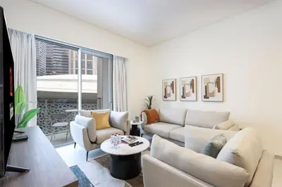 a living room with a couch and a table at Livbnb-Modern 2BR with Partial Burj Khalifa View in Dubai