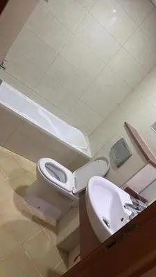 a bathroom with a toilet and a sink at Supper holly days home in Dubai