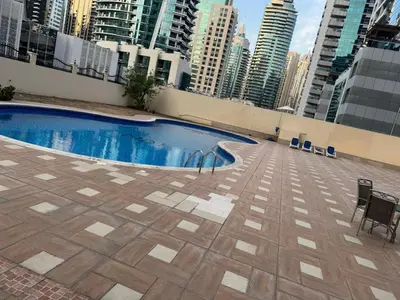 a swimming pool on top of a building with tall buildings at Supper holly days home in Dubai